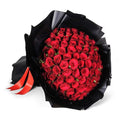 Bouquet of red roses wrapped in black paper wrap
