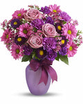 Bouquet of pink and purple flowers in a purple vase