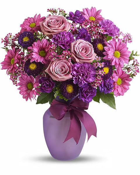 Bouquet of pink and purple flowers in a purple vase