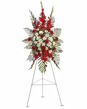 A large floral balloon arrangement on a metal stand, featuring red gladiolus, white daisies, and green foliage, isolated on a white background.